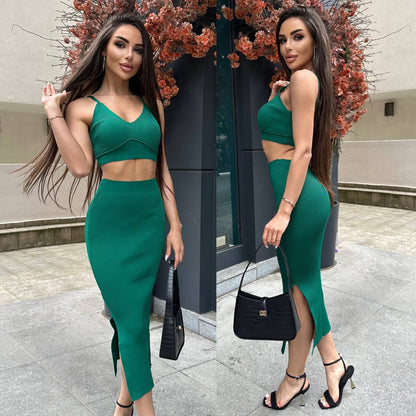 Woman in a green outfit posing outdoors with decorative elements in the background