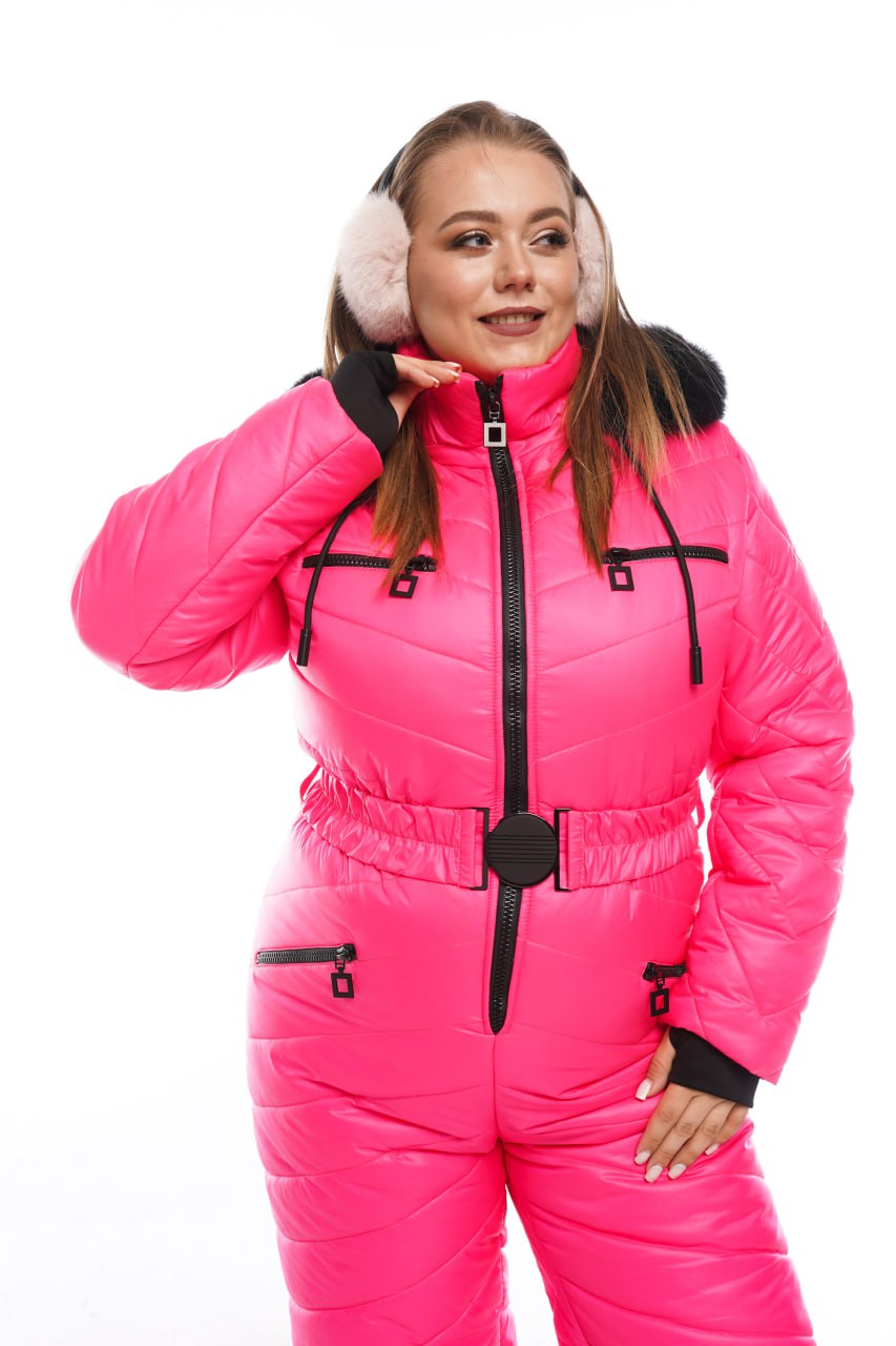 Person wearing a bright pink snowsuit with black zippers on a white background