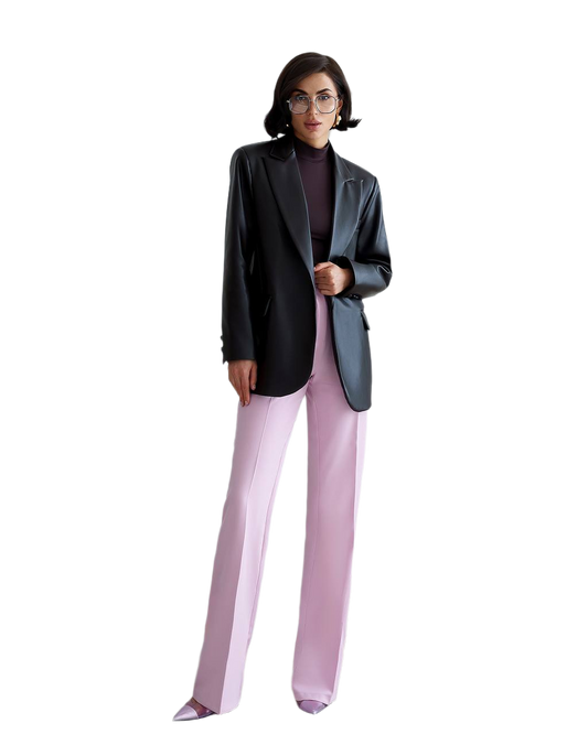 Person wearing a black blazer and light purple pants on a white background