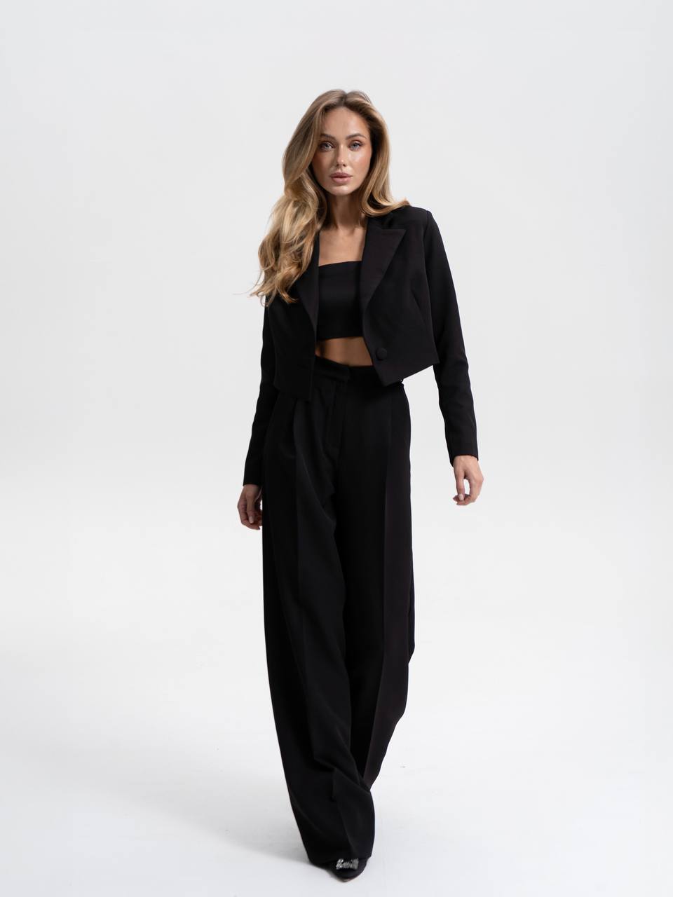 Woman wearing a black outfit on a white background