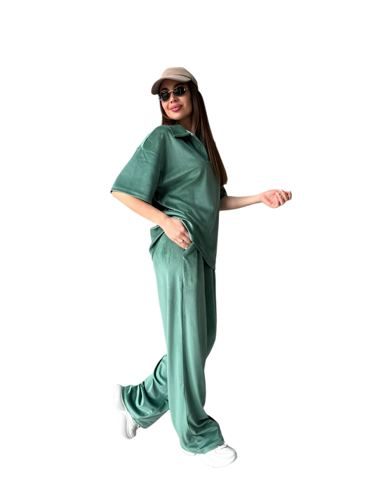 Woman wearing a green outfit with a cap and sunglasses on a white background