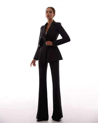 Woman wearing a black suit on a white background