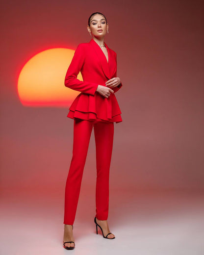 Woman wearing a red suit with a sunset in the background