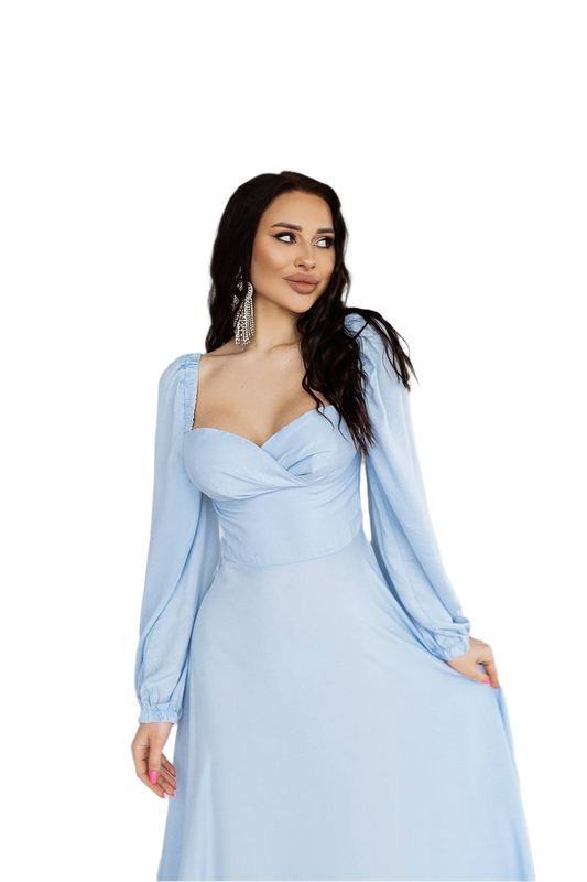 Woman wearing a light blue dress with long sleeves on a white background
