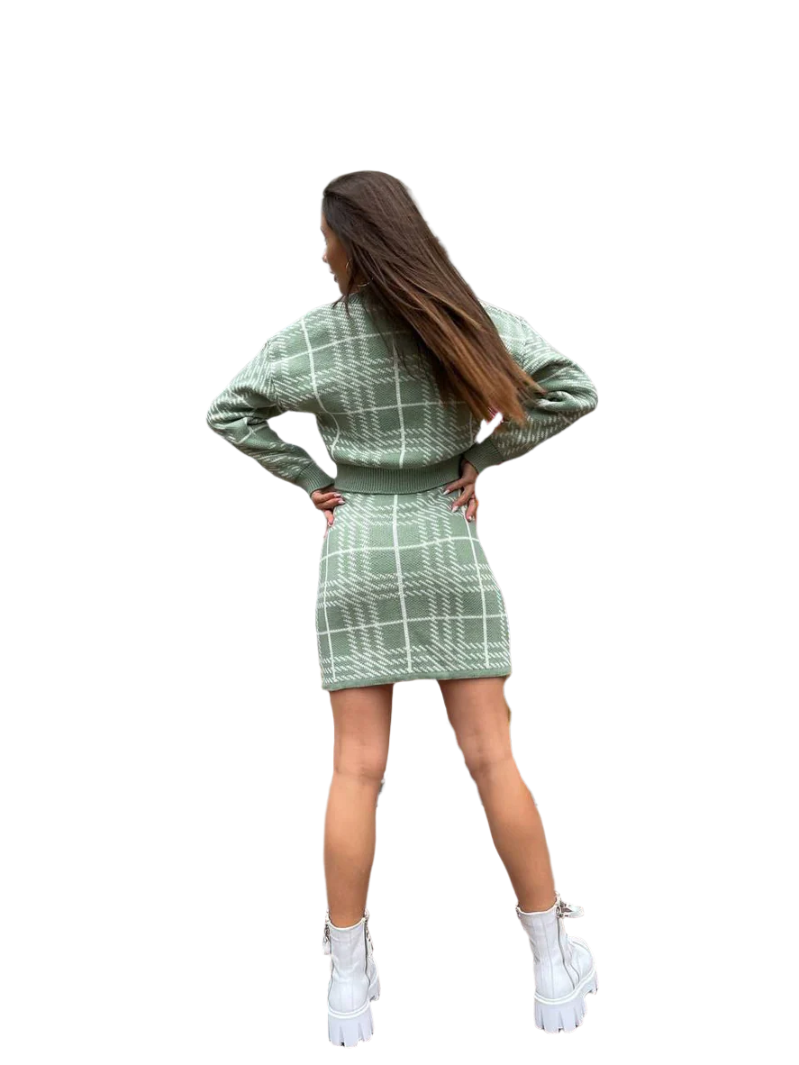 Woman wearing a green plaid outfit on a white background