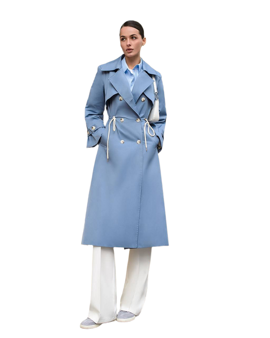 Woman wearing a light blue trench coat on a white background
