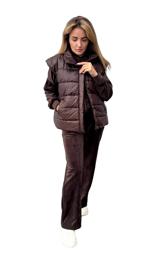 Woman wearing a brown puffer jacket and pants on a white background