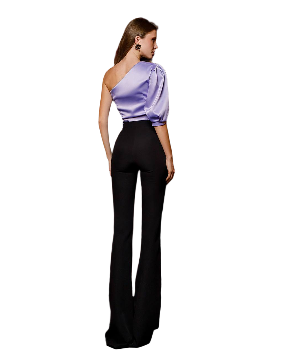Woman wearing a one-shoulder purple top and black pants on a white background