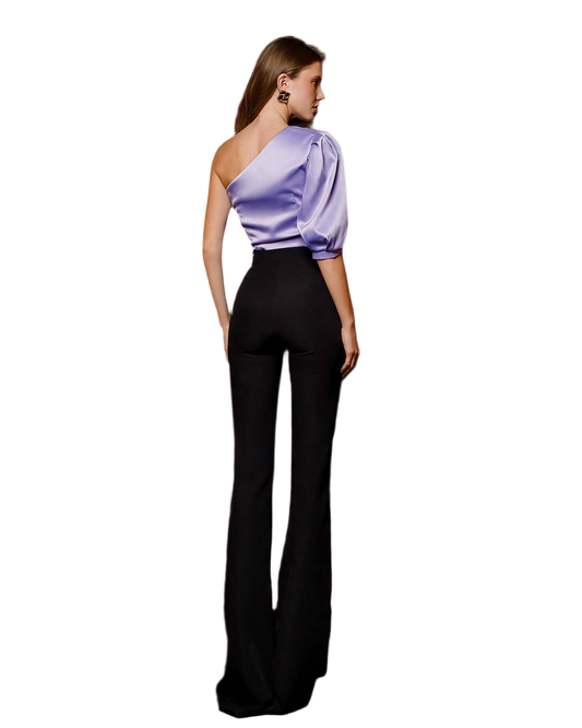 Woman wearing a one-shoulder purple top and black pants on a white background