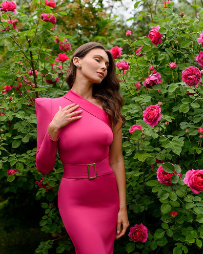 Woman in a pink dress standing among pink flowers