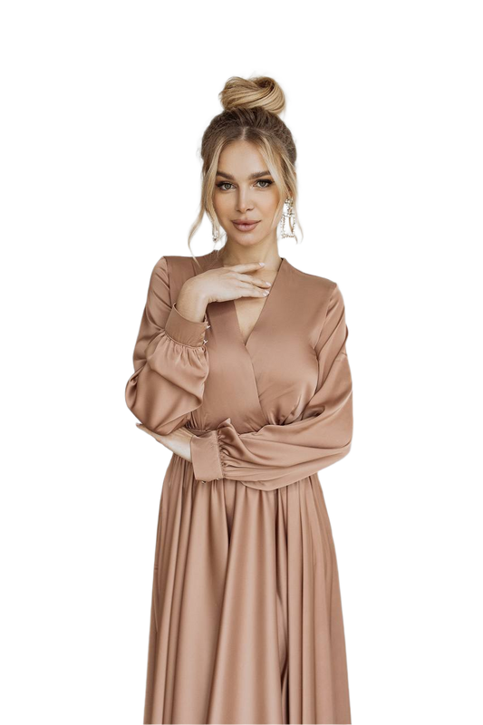 Woman wearing a long, light brown dress on a white background