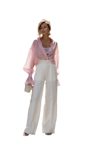Person wearing a pink blouse and white pants on a white background