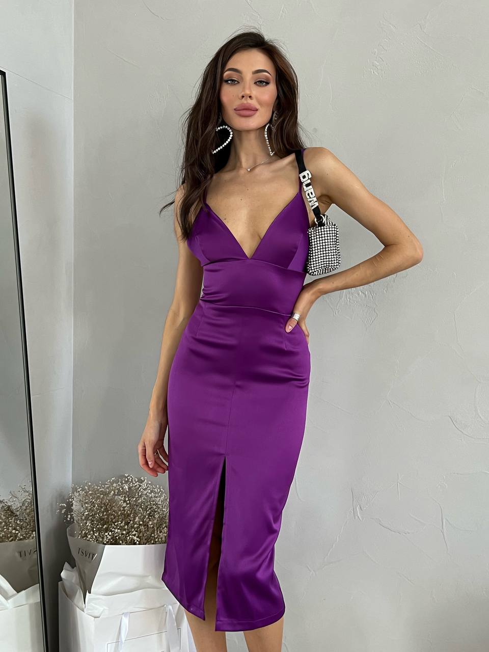 Woman wearing a purple dress with a white background