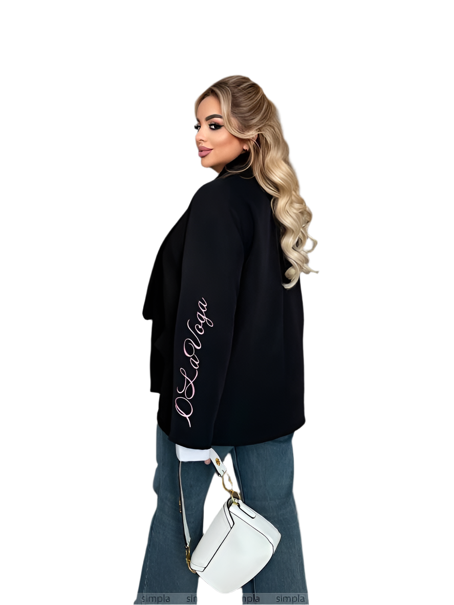 Woman wearing a black oversized sweater with 'La La Vaga' text, holding a white handbag on a white background.