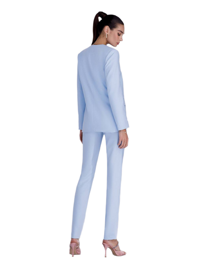 Woman wearing a light blue suit on a white background