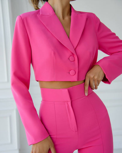 Person wearing a bright pink suit with a white background
