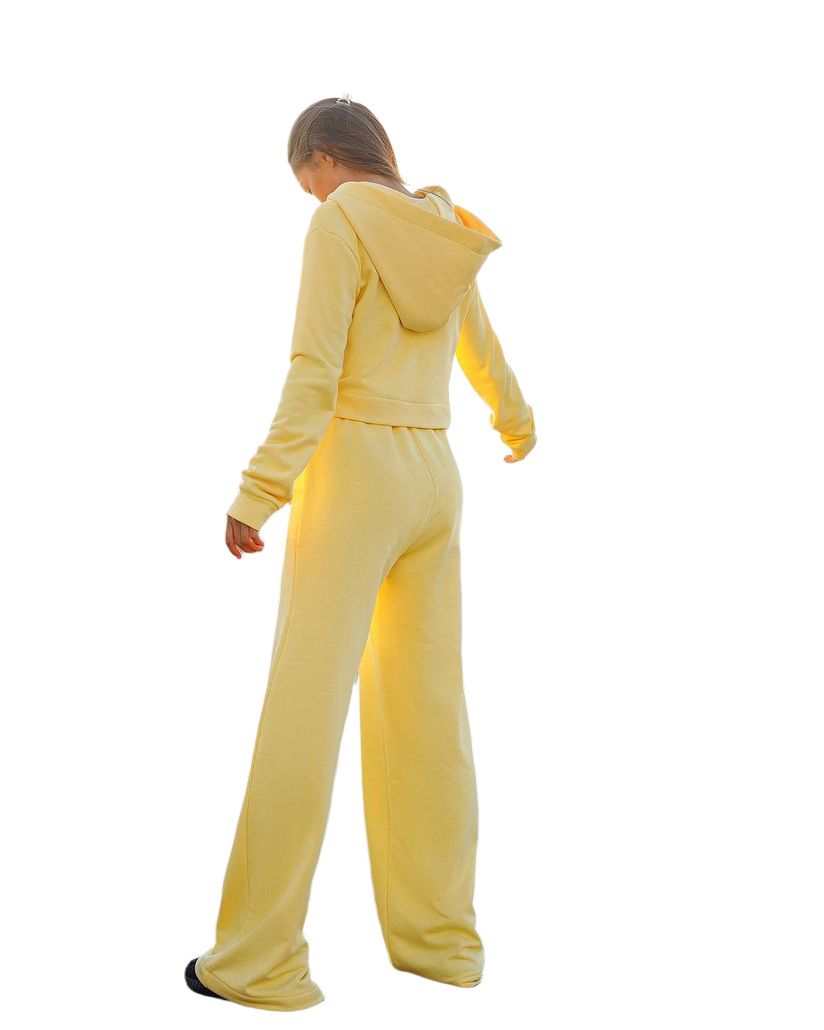 Person wearing a yellow tracksuit on a white background
