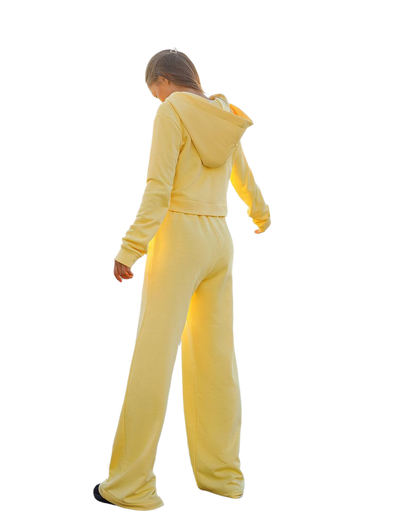 Person wearing a yellow tracksuit on a white background