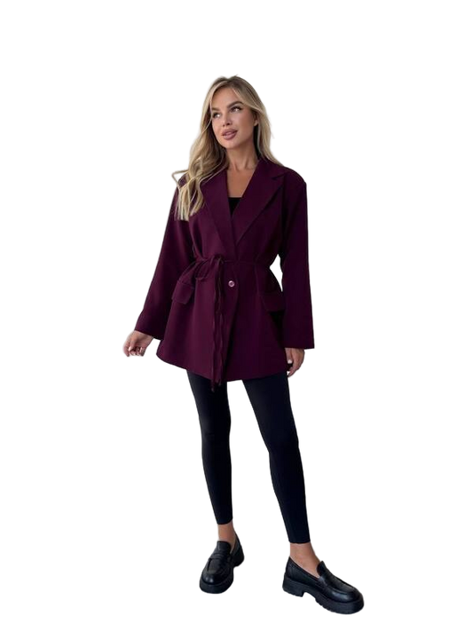 Woman wearing a burgundy coat on a white background