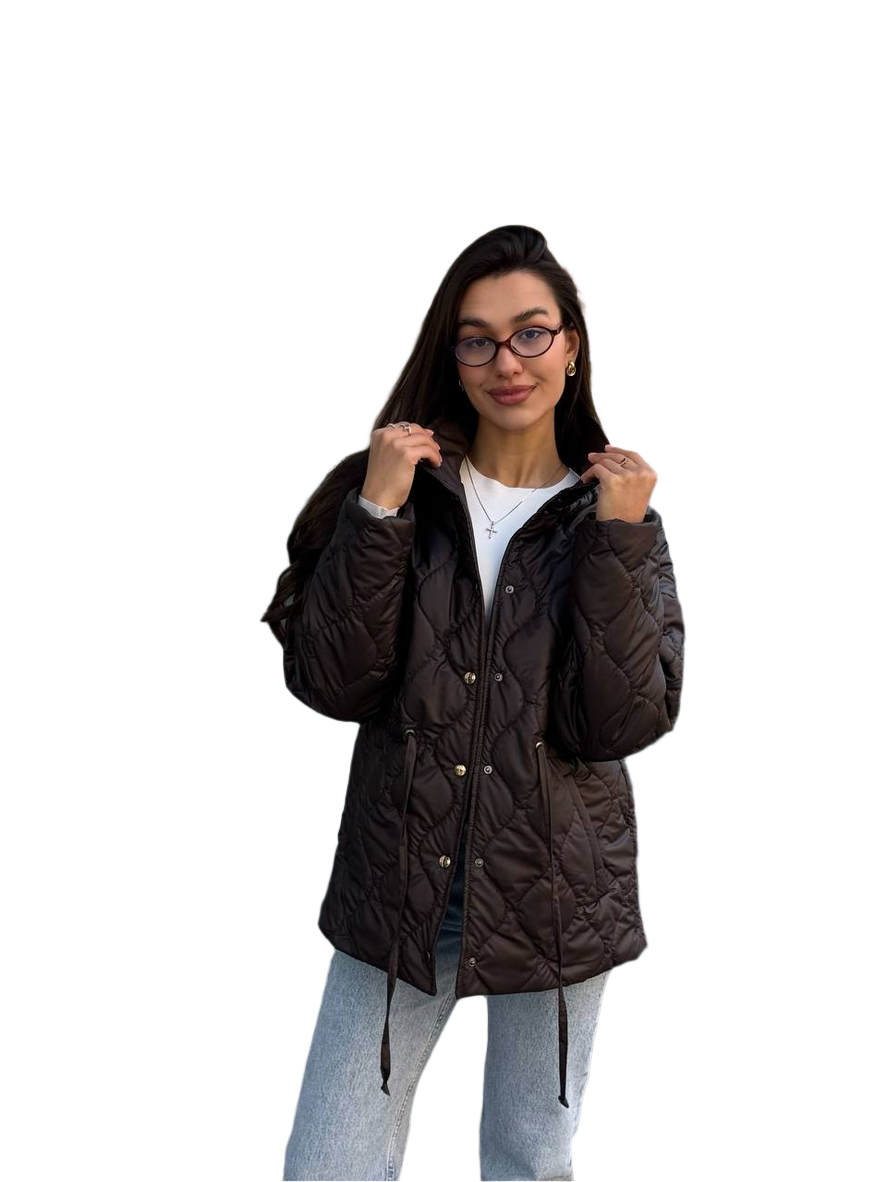 Woman wearing a dark brown quilted jacket on a white background