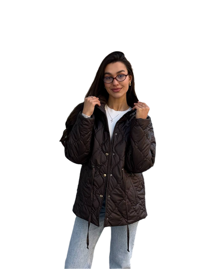 Woman wearing a dark brown quilted jacket on a white background