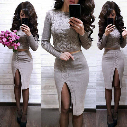 Woman taking a mirror selfie wearing a gray cable knit sweater and skirt set, holding pink flowers.