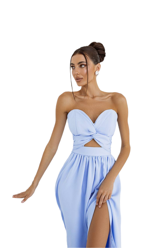 Woman wearing a light blue strapless dress with a cutout design on a white background