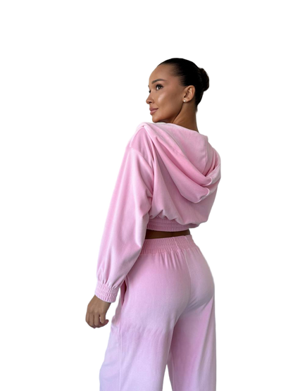 Woman wearing a pink outfit on a white background