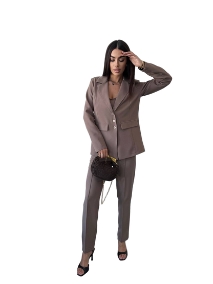 Woman wearing a brown suit holding a handbag on a white background