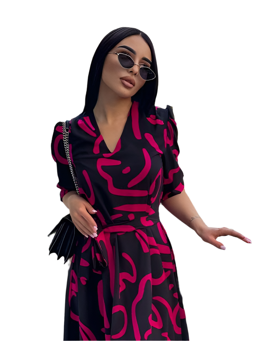 Woman wearing a black and pink patterned dress with sunglasses on a white background