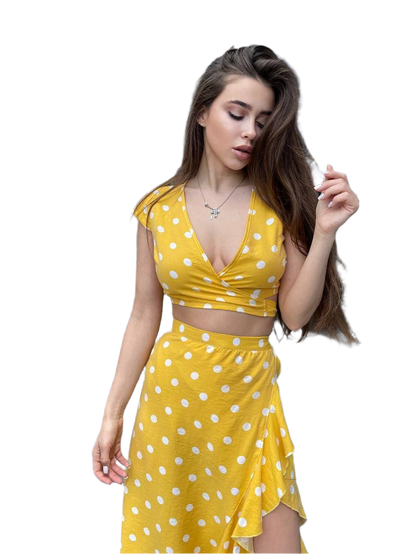 Woman wearing a yellow polka dot dress on a white background