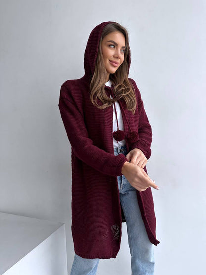 Woman wearing a burgundy hooded cardigan against a white background