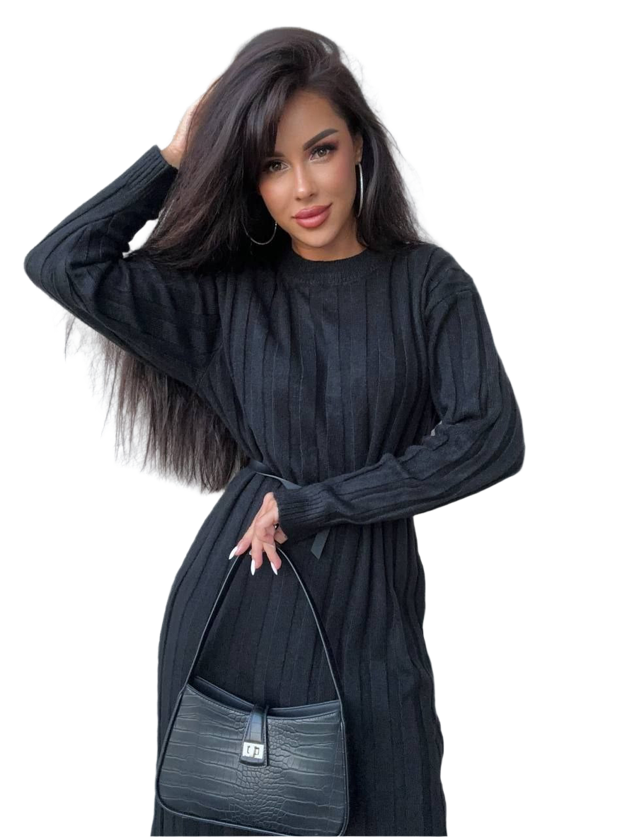 Woman wearing a black dress holding a matching handbag on a white background