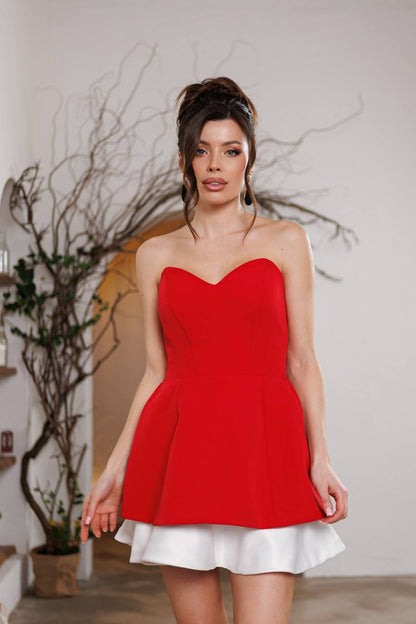 Woman wearing a red dress with a white skirt in an indoor setting