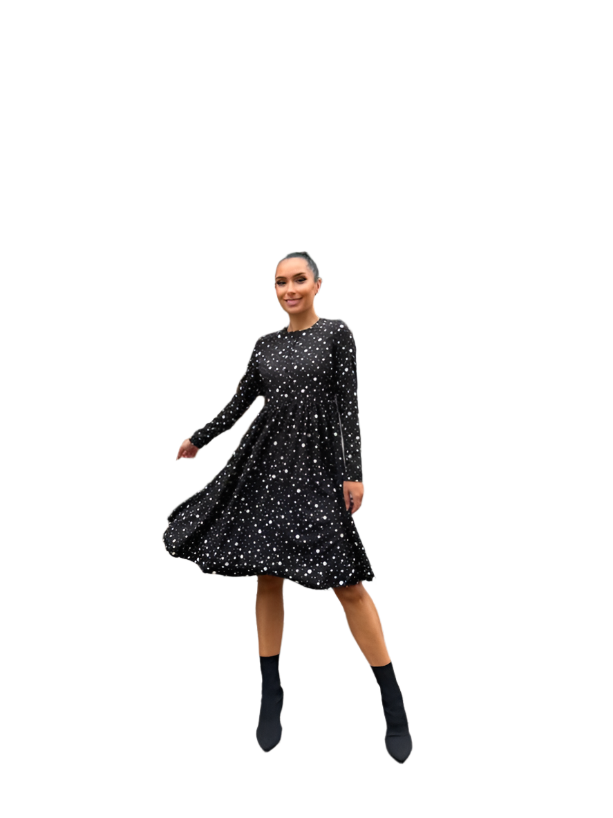 Woman wearing a black dress with white polka dots on a white background