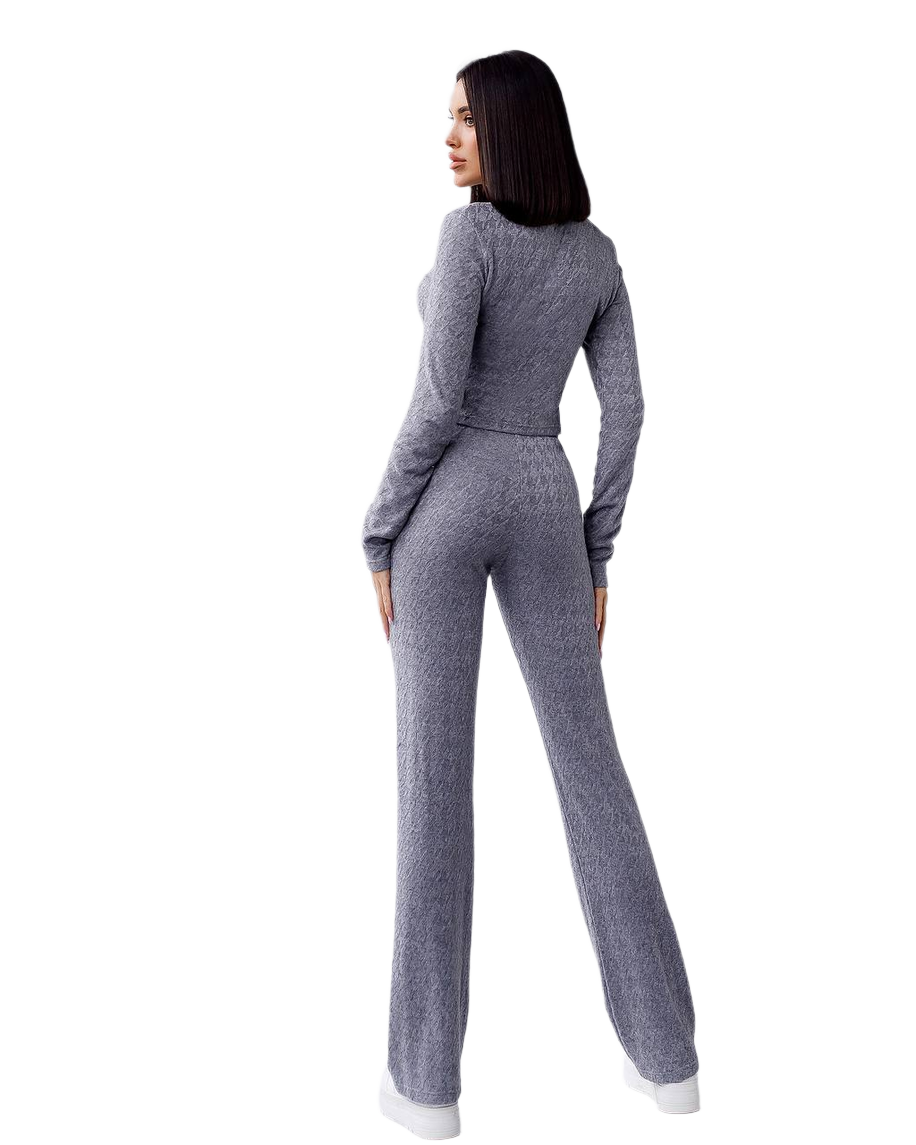 Woman wearing a gray knit outfit on a white background