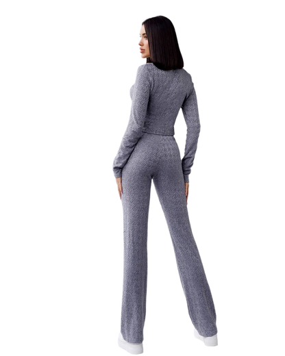 Woman wearing a gray knit outfit on a white background