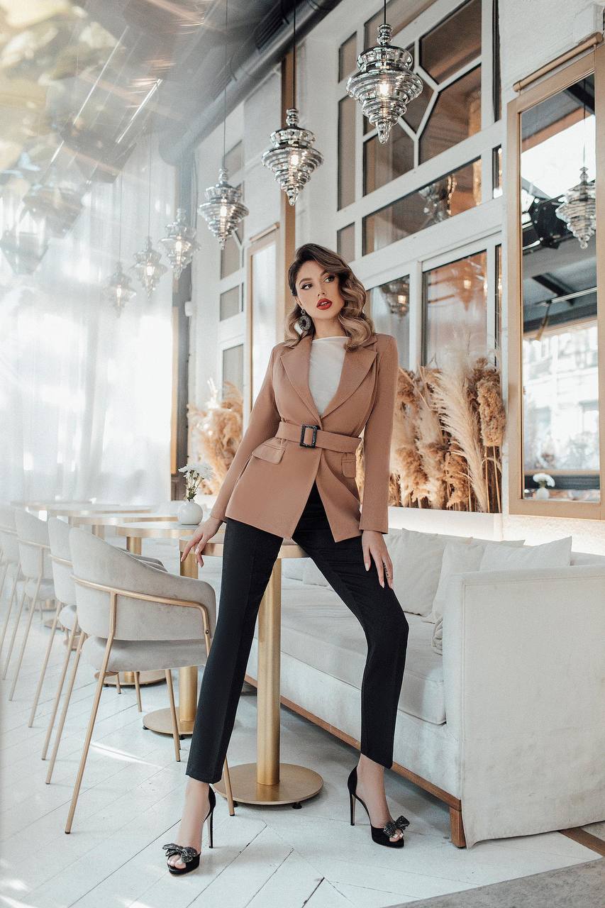 Woman in a stylish outfit standing in a modern interior setting