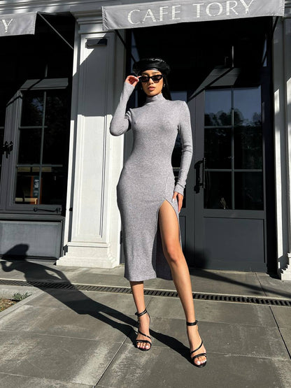 Woman in a gray dress standing outside a cafe named 'Cafe Tory'.