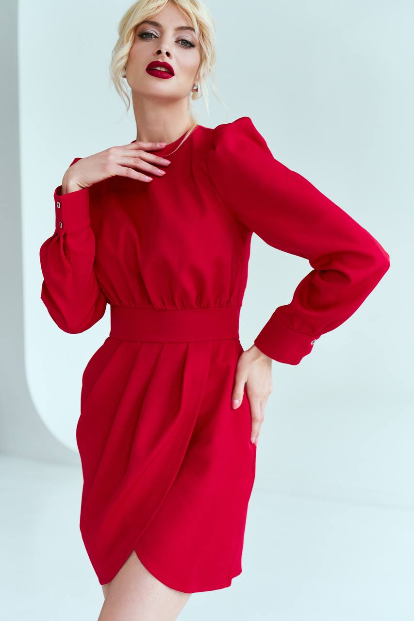 Woman wearing a red dress against a light background