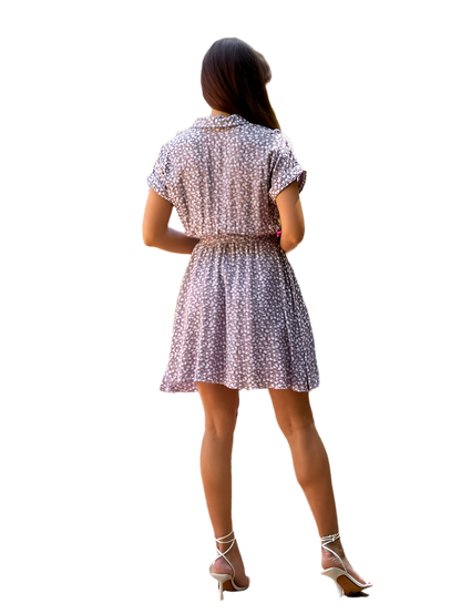 Woman wearing a patterned dress on a white background