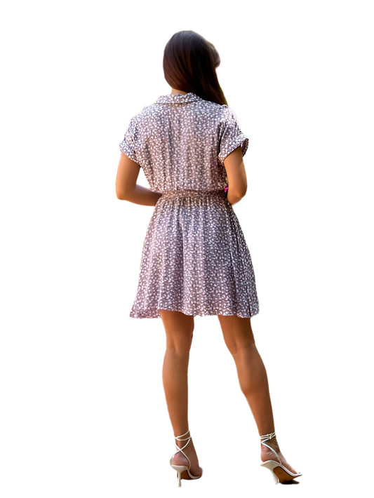 Woman wearing a patterned dress on a white background