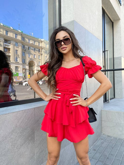 Woman in a red dress standing on a city street