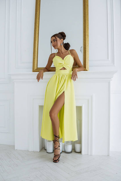 Woman in a yellow dress standing in front of a mirror with a white wall background
