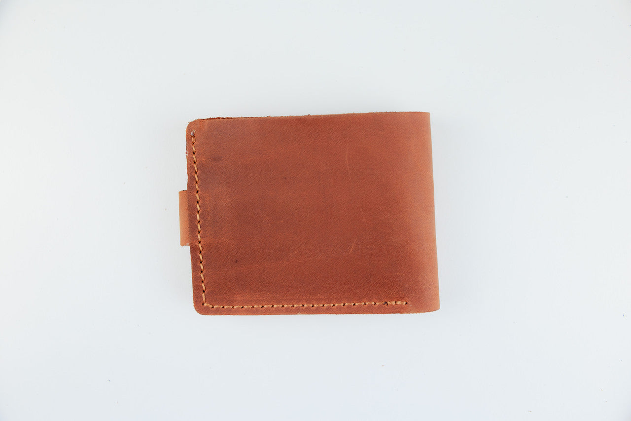A brown leather bifold wallet with visible stitching on a plain white background.
