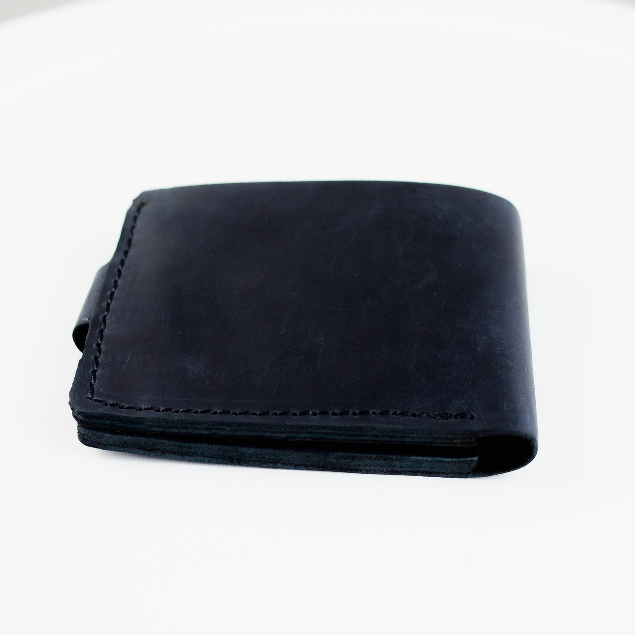 A black leather bifold wallet with visible stitching, shown closed on a plain white background.