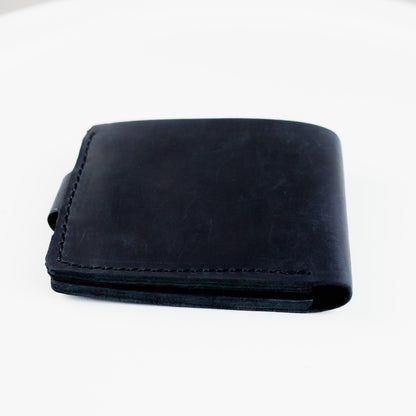 A black leather bifold wallet with visible stitching, shown closed on a plain white background.