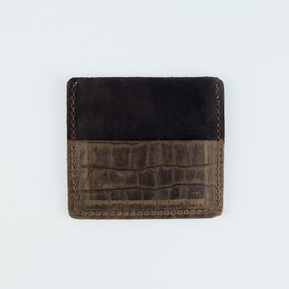 A small leather card holder wallet with a split design, featuring a dark brown suede-like top half and a textured brown crocodile-embossed bottom half, shown on a plain white background.