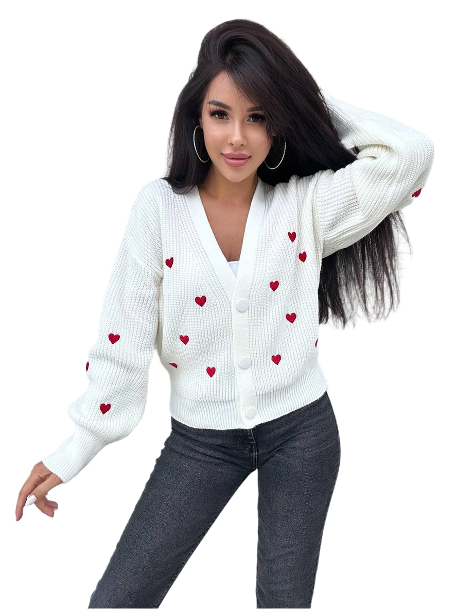 Woman wearing a white cardigan with red heart patterns on a white background