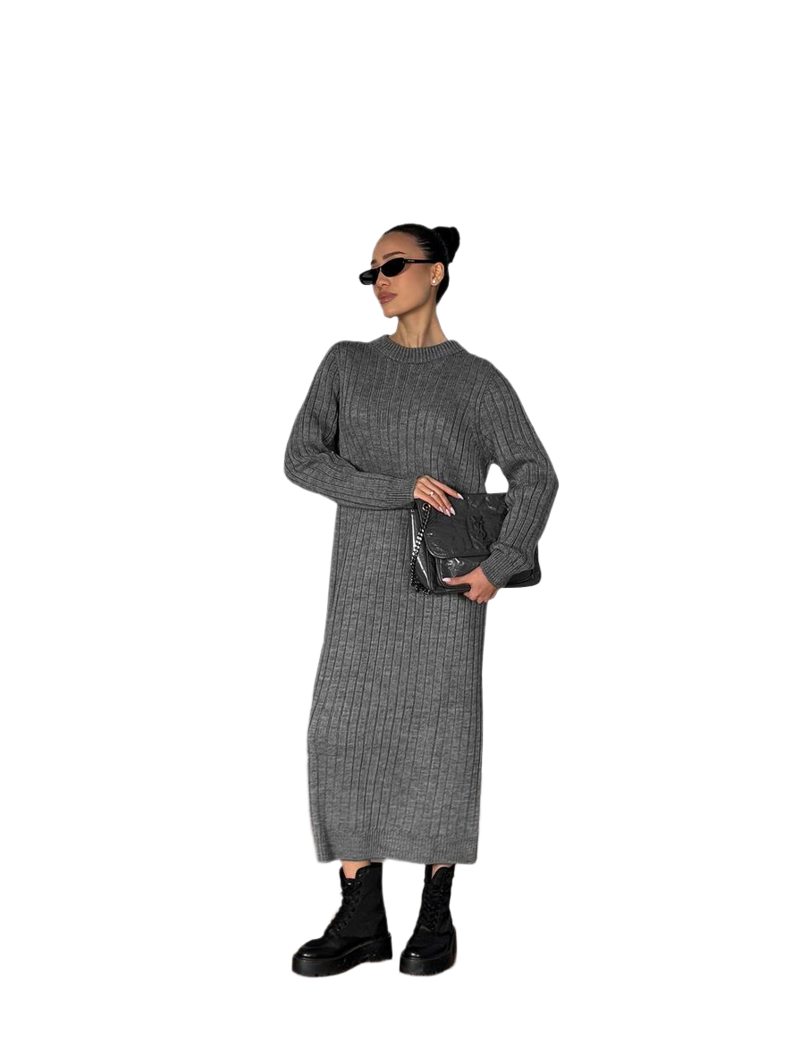 Woman wearing a gray ribbed dress holding a black clutch against a white background